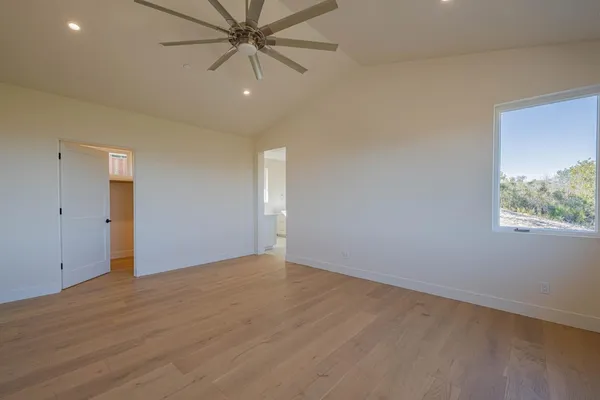 a room with a window bed and cabinets