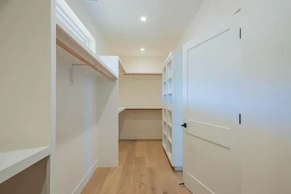 a view of hallway with wooden floor