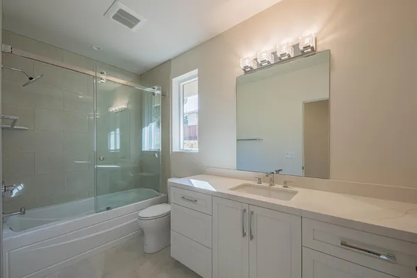 a bathroom with a shower and a toilet