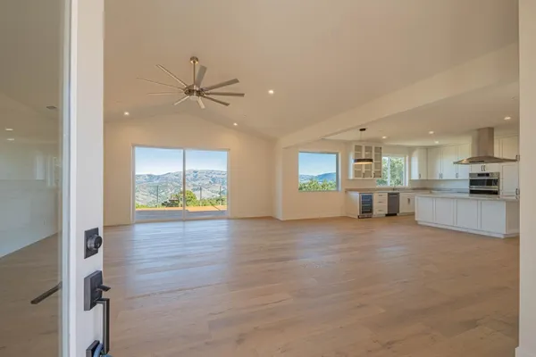 an empty room with windows and entrance