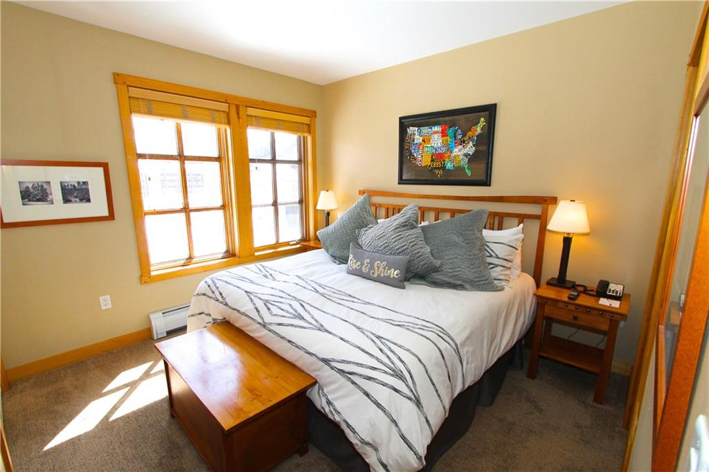 910 Copper Road, Unit 303 Copper Mountain, CO 80443 - Photo 14 of 26 a bedroom with a bed and a window