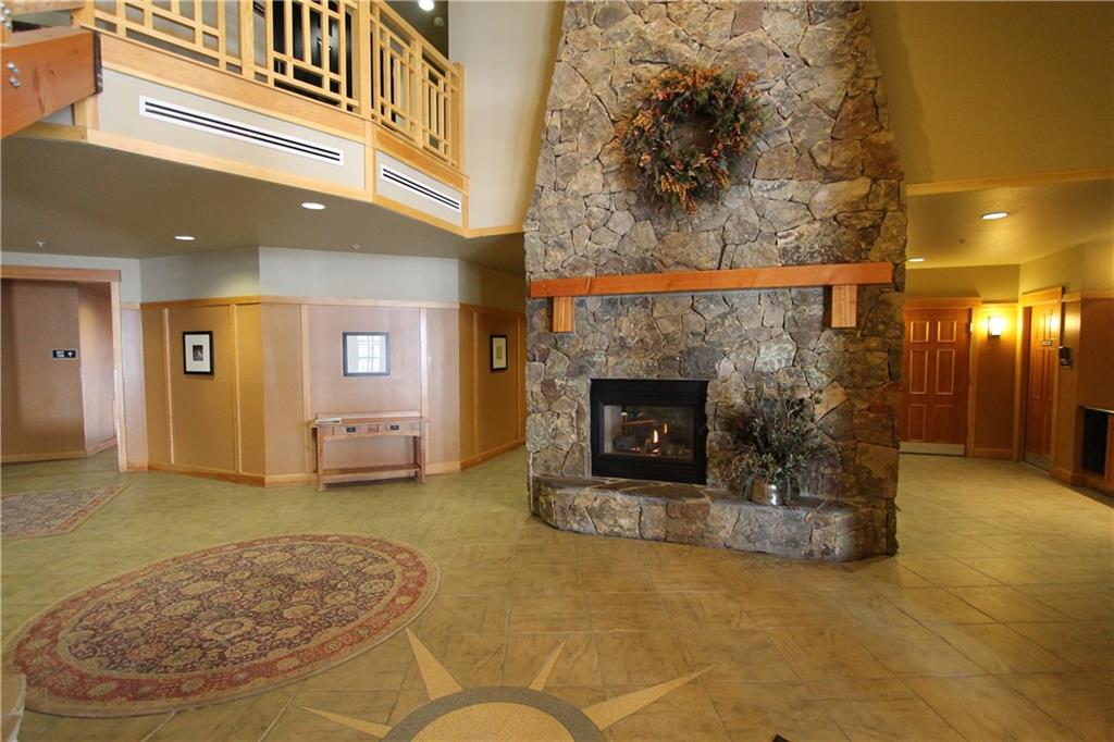 910 Copper Road, Unit 303 Copper Mountain, CO 80443 - Photo 26 of 26 a view of a livingroom with a fireplace and a chandelier