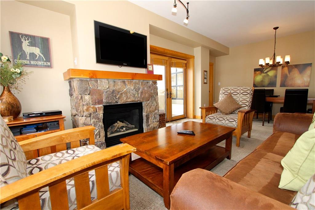 910 Copper Road, Unit 303 Copper Mountain, CO 80443 - Photo 4 of 26 a living room with furniture a flat screen tv and a fireplace