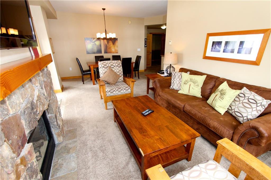 910 Copper Road, Unit 303 Copper Mountain, CO 80443 - Photo 5 of 26 a living room with furniture and a chandelier