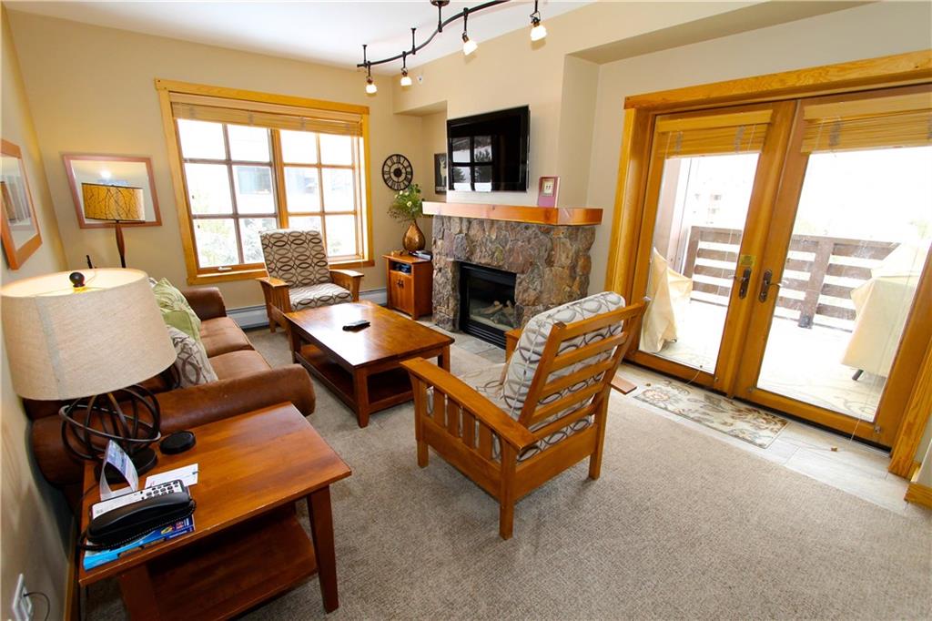 910 Copper Road, Unit 303 Copper Mountain, CO 80443 - Photo 6 of 26 a living room with furniture and a fireplace