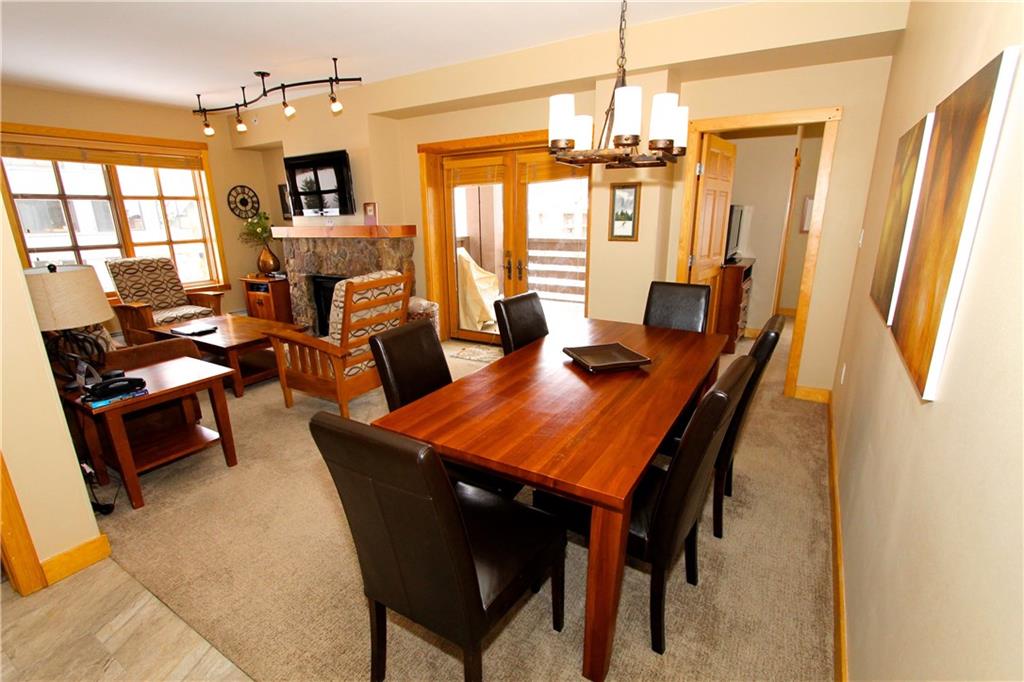 910 Copper Road, Unit 303 Copper Mountain, CO 80443 - Photo 8 of 26 a dining room with furniture a chandelier and window