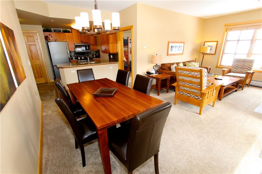 910 Copper Road, Unit 303 Copper Mountain, CO 80443 - Photo 9 of 26 a view of a dining room with furniture a chandelier and wooden floor