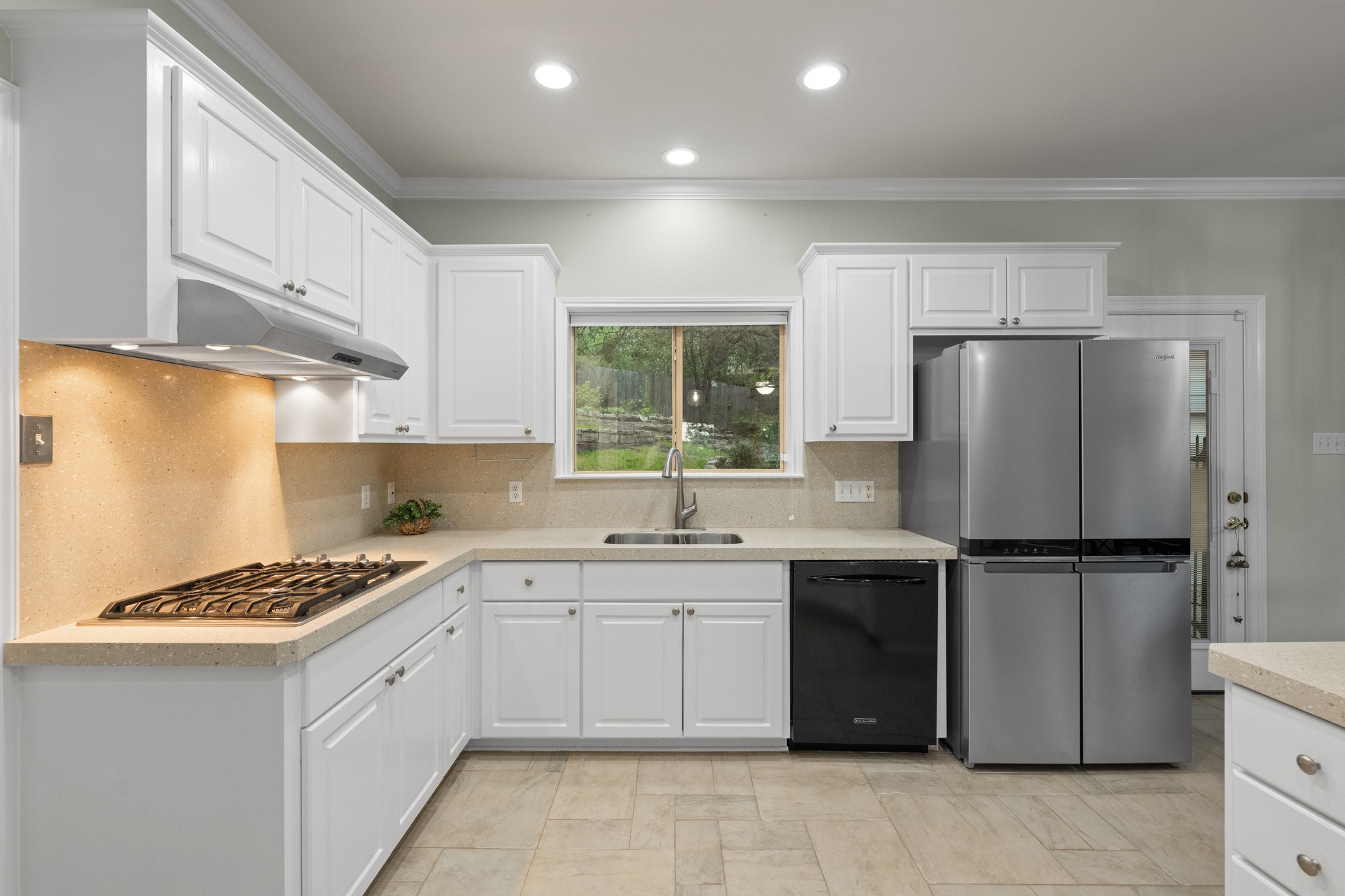 6004 Mt Bonnell Road Austin, TX 78731 - Photo 12 of 24 a kitchen with a sink a refrigerator and cabinets