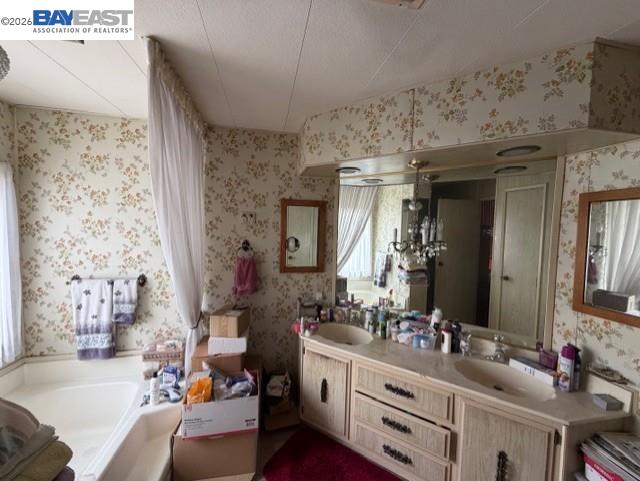 29266 Nantucket Way Hayward, CA 94544 - Photo 7 of 24 a bathroom with a bathtub sink and mirror
