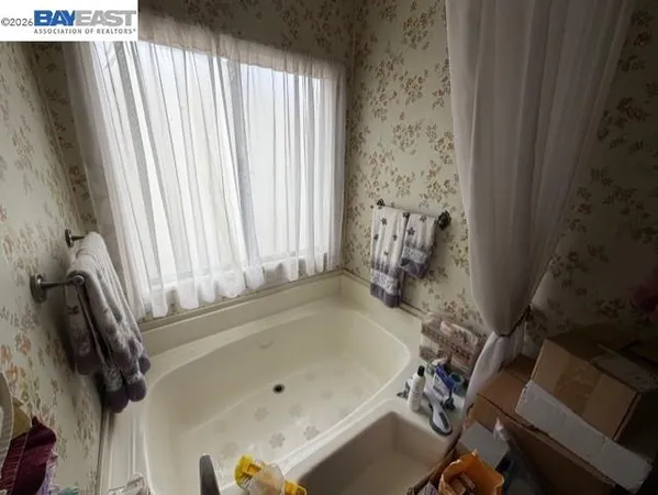 a bath tub sitting in a bathroom next to a window