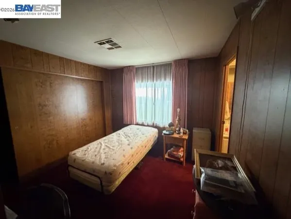 a bedroom with bed and window