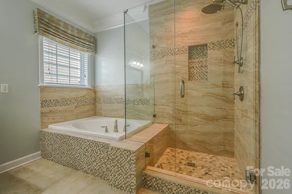 a bathroom with a bathtub and shower