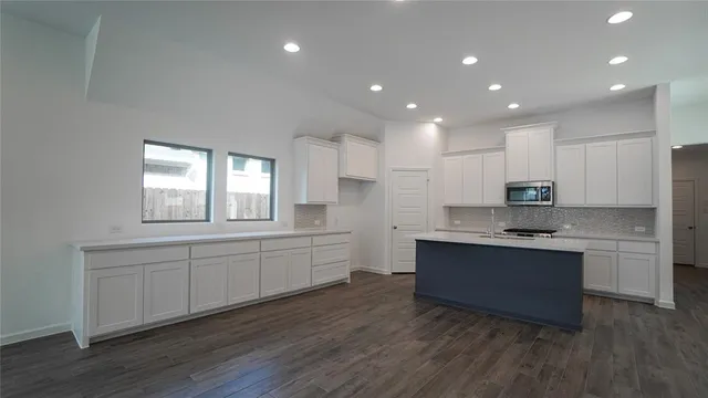 a view of cabinets and wooden floor