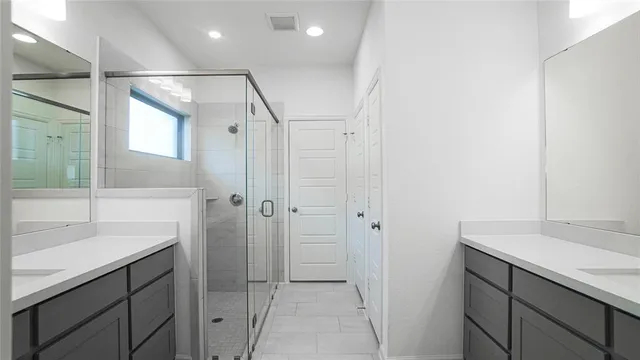a bathroom with a granite countertop sink mirror and double