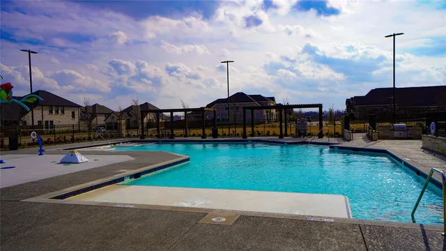 a view of a swimming pool with outdoor seating