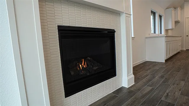 a open kitchen with white cabinets and chandelier