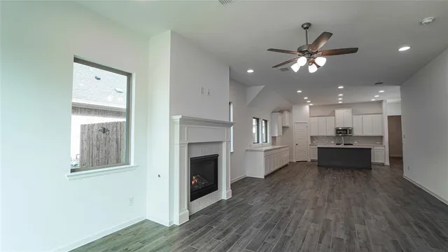a kitchen with kitchen island sink stove and cabinets