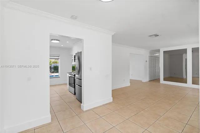 a view of a refrigerator in kitchen and livingroom