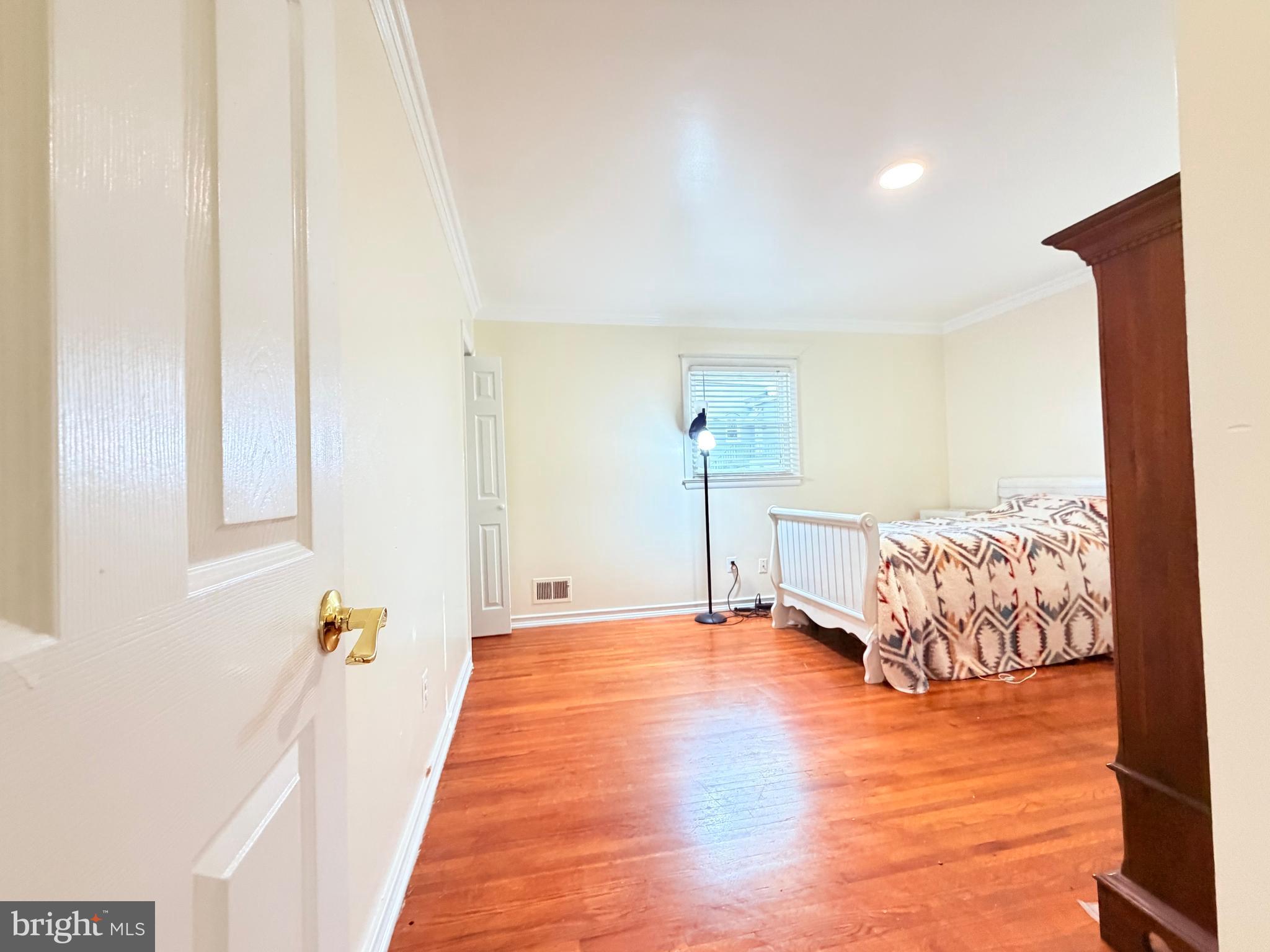 2003 Prichard Road Silver Spring, MD 20902 - Photo 14 of 45 a view of a bedroom with wooden floor and a rug