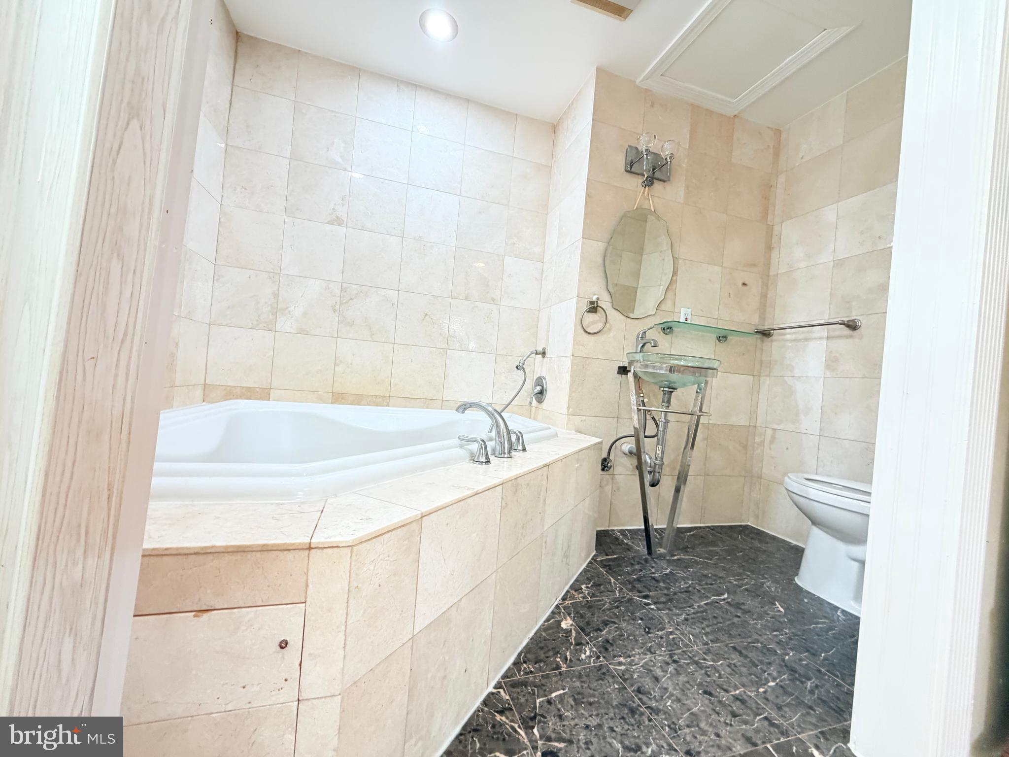 2003 Prichard Road Silver Spring, MD 20902 - Photo 17 of 45 a bathroom with a sink a toilet and shower