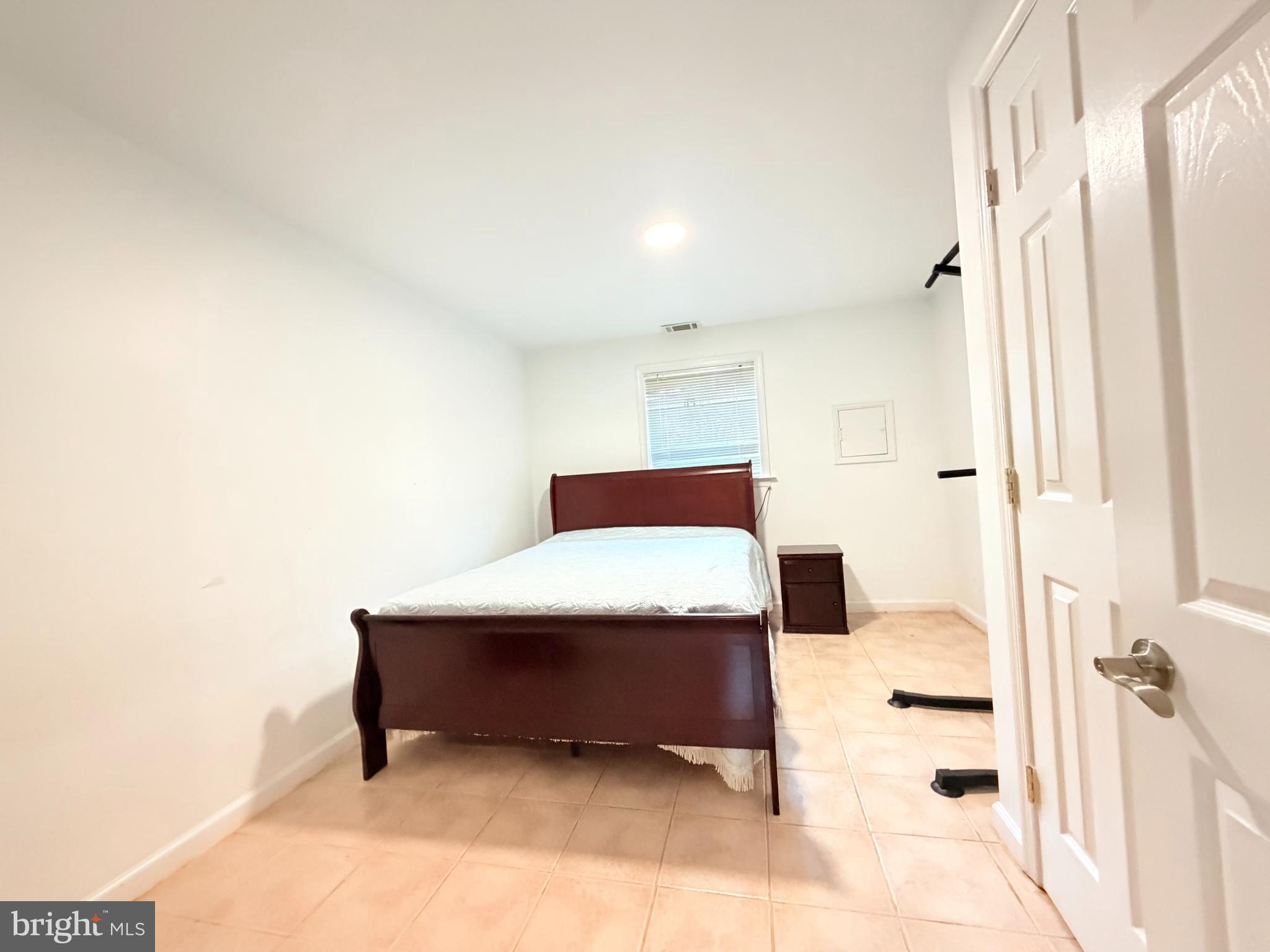 2003 Prichard Road Silver Spring, MD 20902 - Photo 39 of 45 a bedroom with a bed and a table