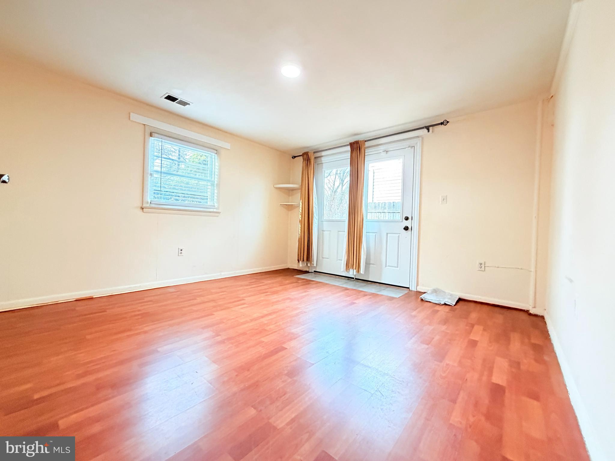 2003 Prichard Road Silver Spring, MD 20902 - Photo 42 of 45 a view of an empty room with wooden floor and a window