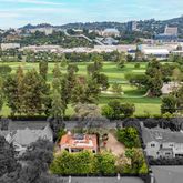 an aerial view of residential houses with outdoor space and river