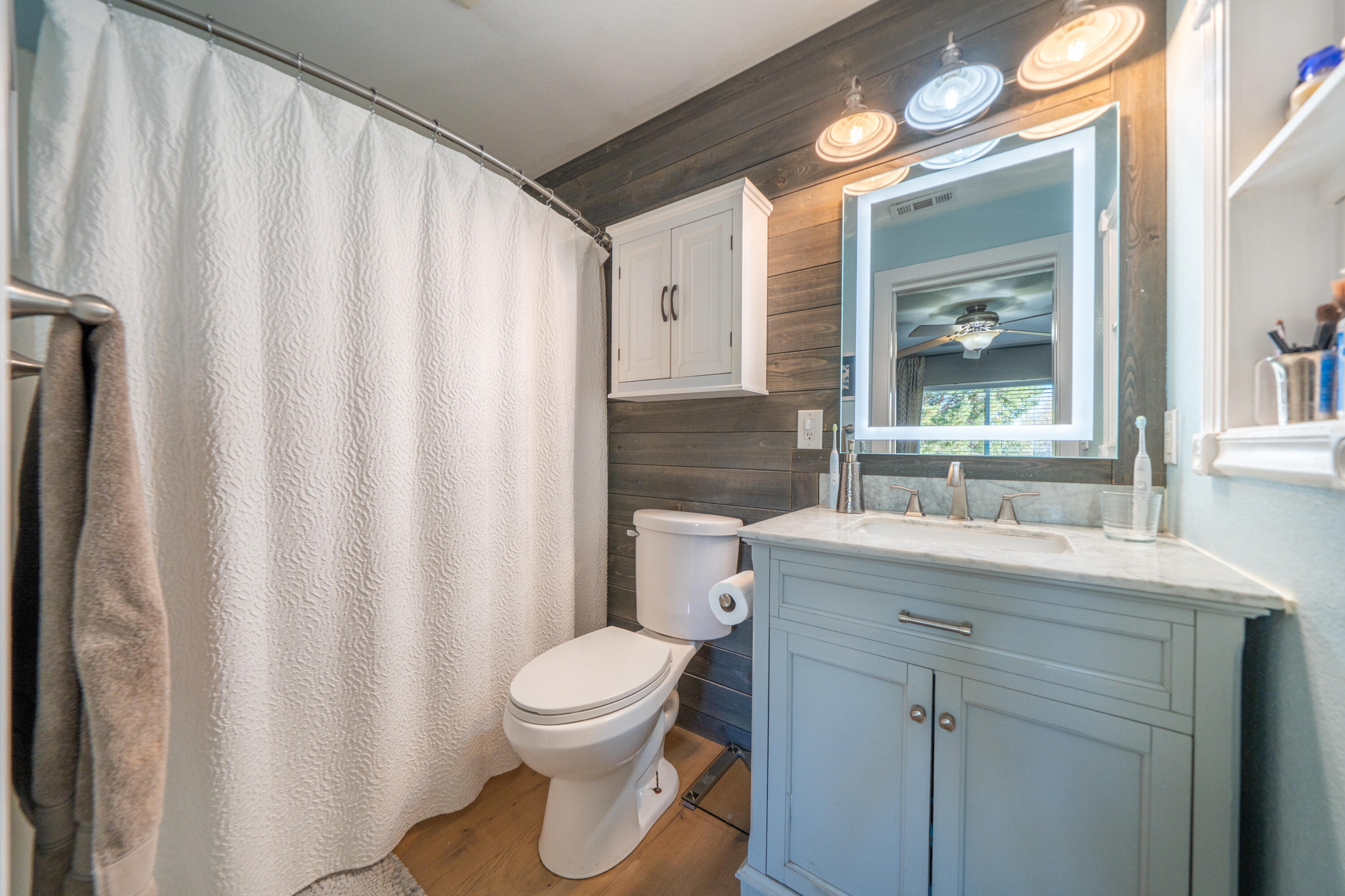 2385 Alexander Avenue Anderson, CA 96007 - Photo 24 of 72 a bathroom with a sink a toilet and a mirror