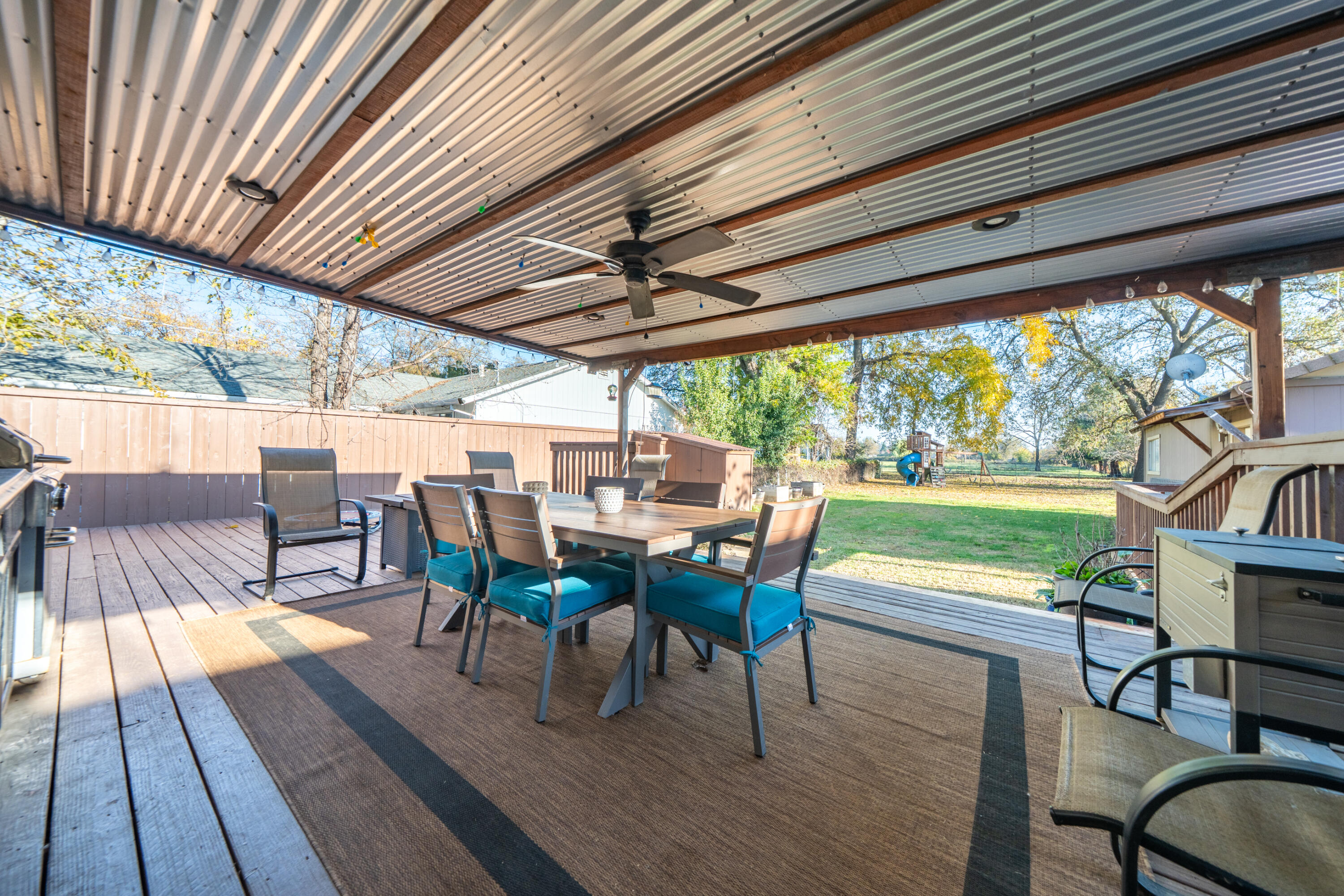 2385 Alexander Avenue Anderson, CA 96007 - Photo 33 of 72 a view of a patio with table and chairs and wooden floor