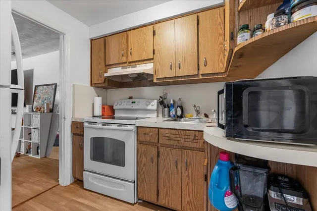 a kitchen with stainless steel appliances granite countertop a stove a microwave and cabinets