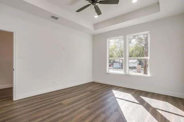 a view of an empty room with wooden floor