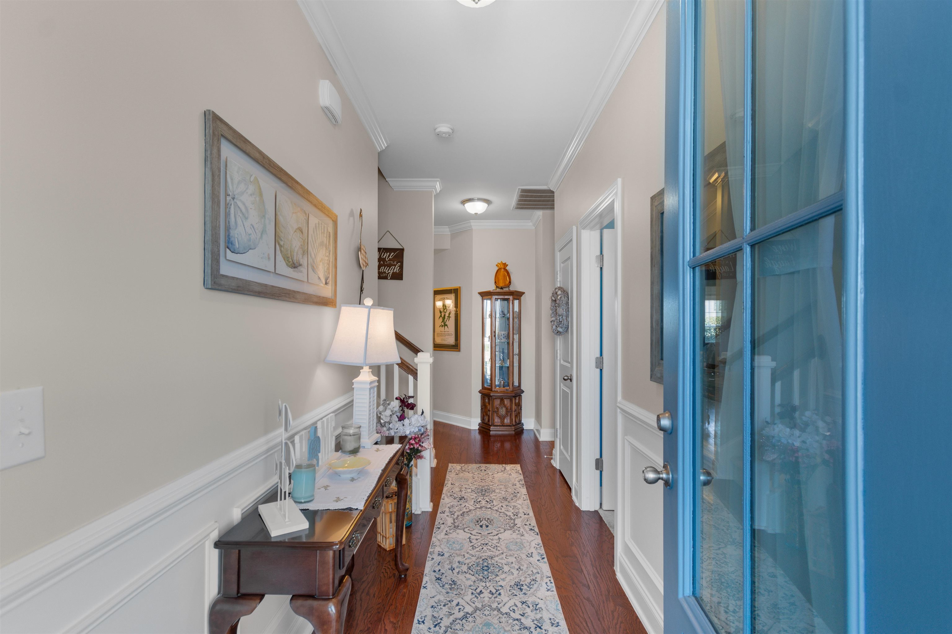 5459 Elba Way, Unit 1501 Myrtle Beach, SC 29579 - Photo 3 of 31 Entryway with crown molding, a wainscoted wall, a decorative wall, and dark wood-type flooring