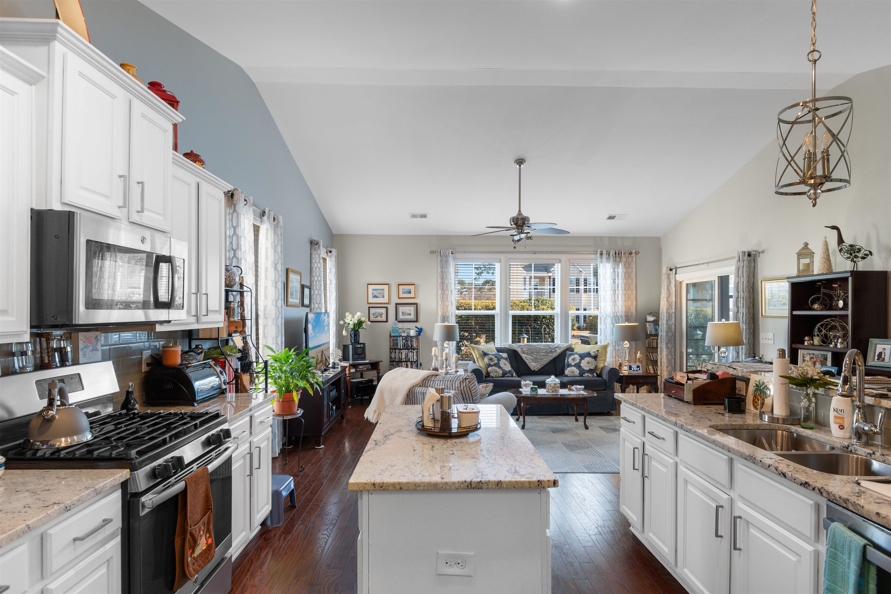 5459 Elba Way, Unit 1501 Myrtle Beach, SC 29579 - Photo 5 of 31 Kitchen featuring appliances with stainless steel finishes, white cabinets, vaulted ceiling, hanging light fixtures, and light stone countertops