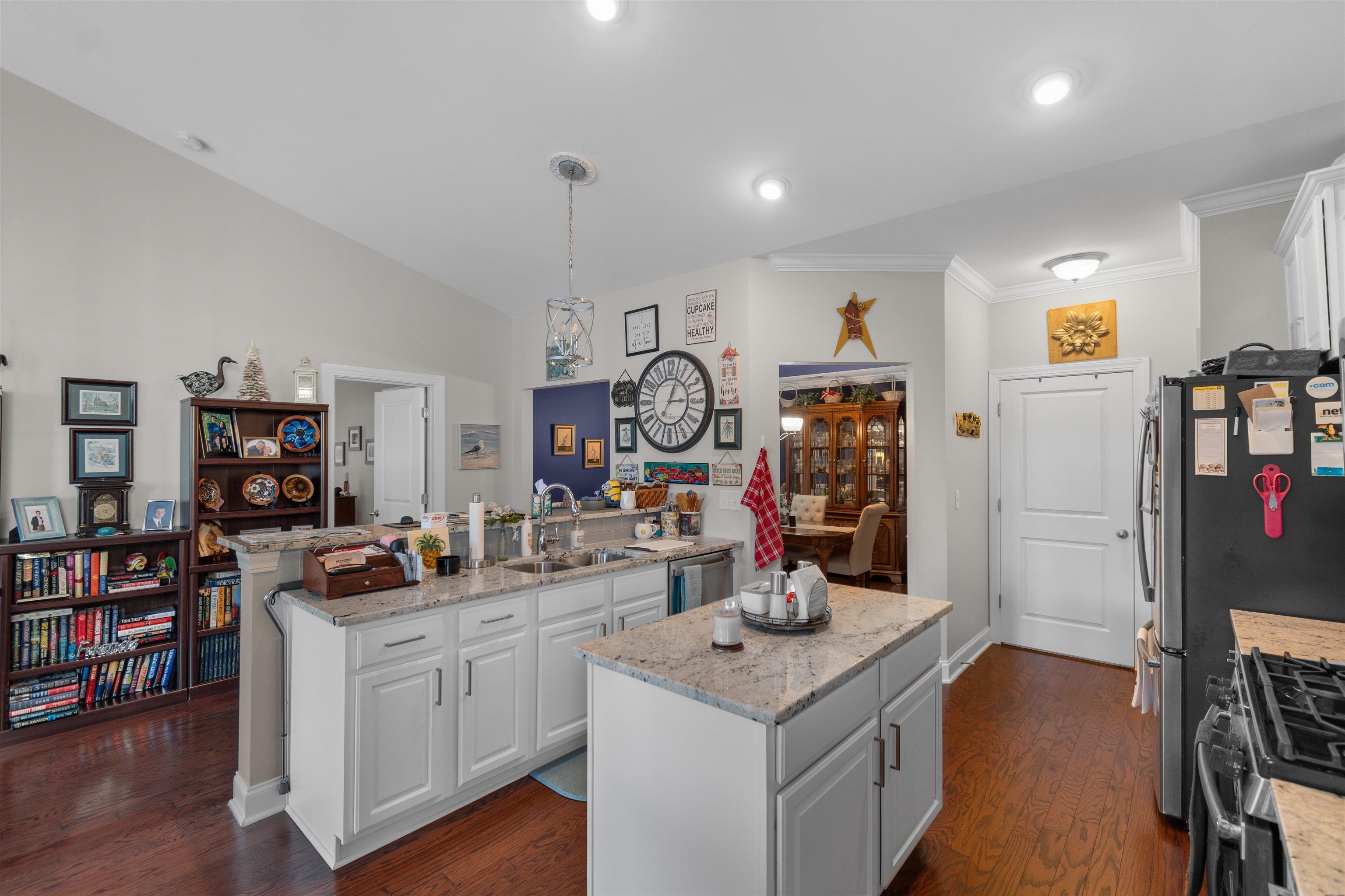 5459 Elba Way, Unit 1501 Myrtle Beach, SC 29579 - Photo 6 of 31 Kitchen featuring white cabinets, pendant lighting, light stone counters, dark wood-type flooring, and crown molding