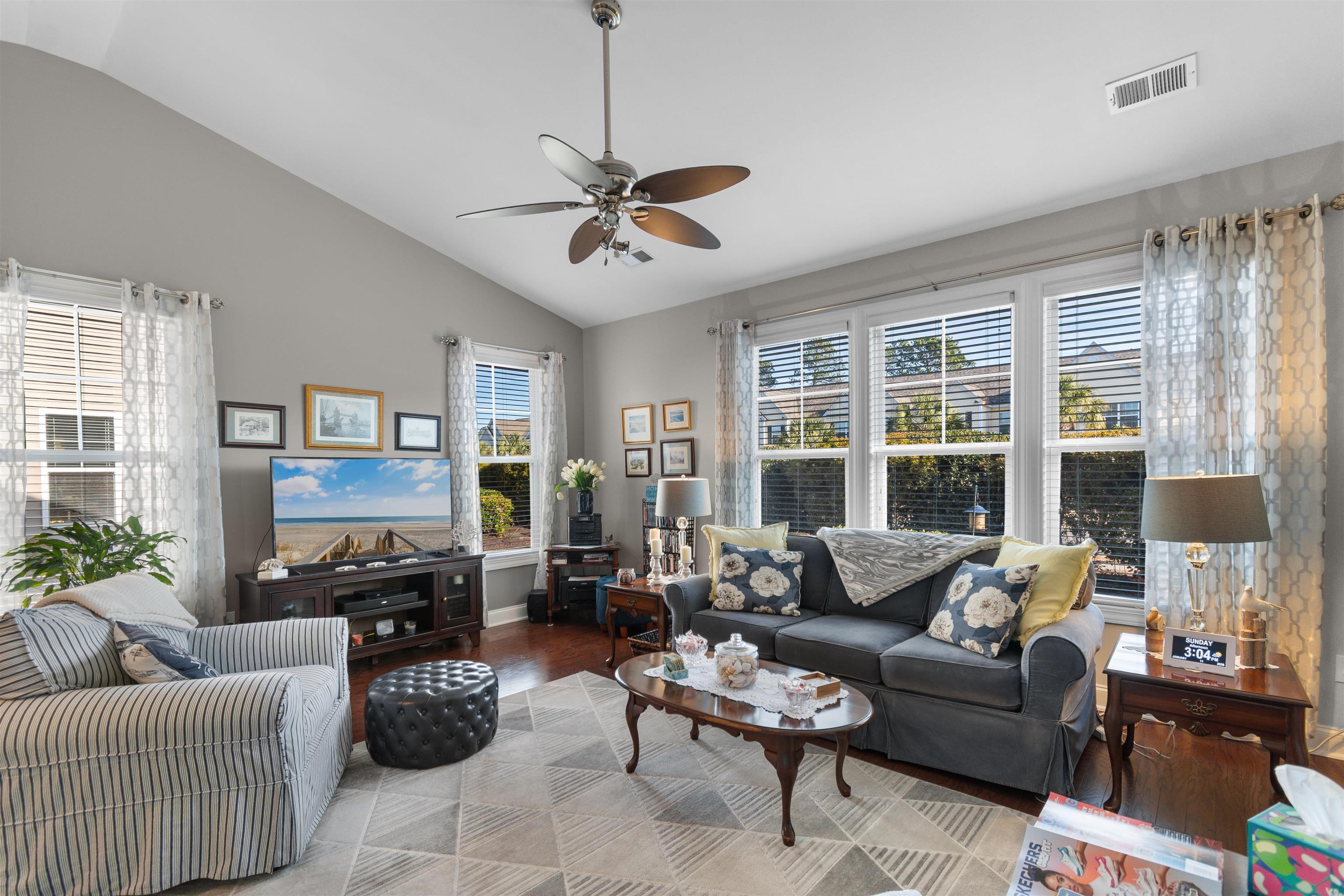 5459 Elba Way, Unit 1501 Myrtle Beach, SC 29579 - Photo 9 of 31 Living room with wood finished floors, healthy amount of natural light, ceiling fan, and high vaulted ceiling