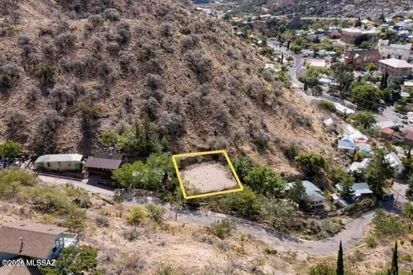 an aerial view of a house with a yard and lake view