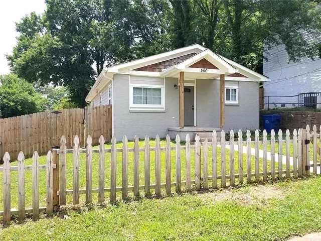 a front view of small house with a garden