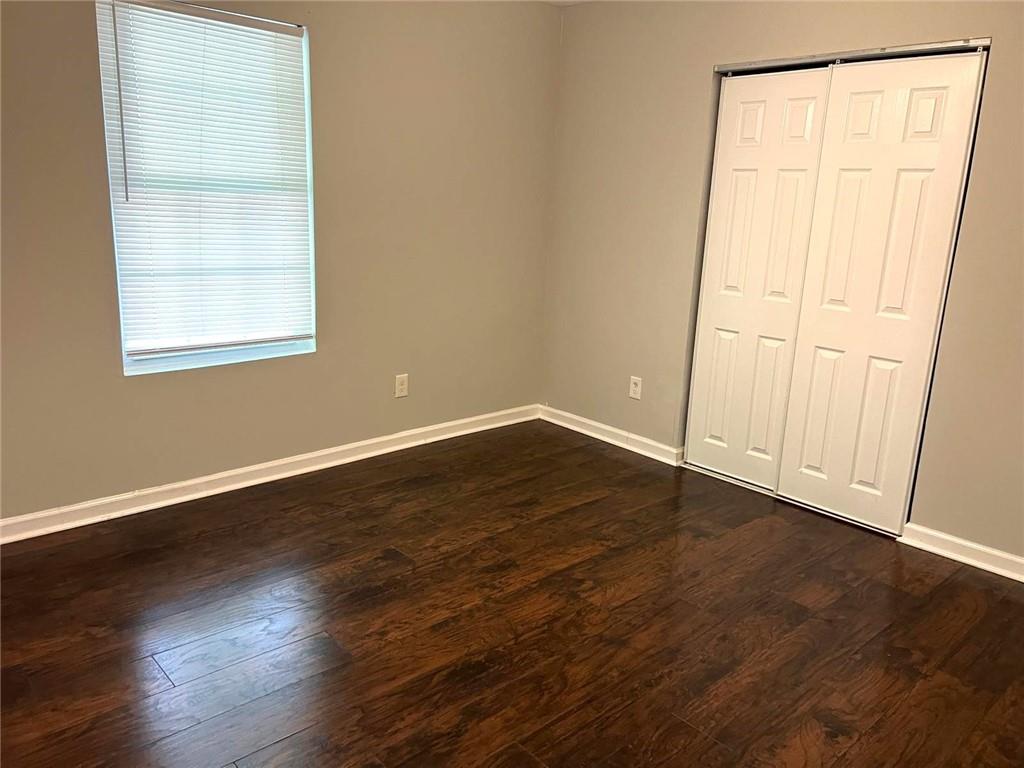 566 Rockwell Street Southwest Atlanta, GA 30310 - Photo 12 of 23 an empty room with wooden floor and windows