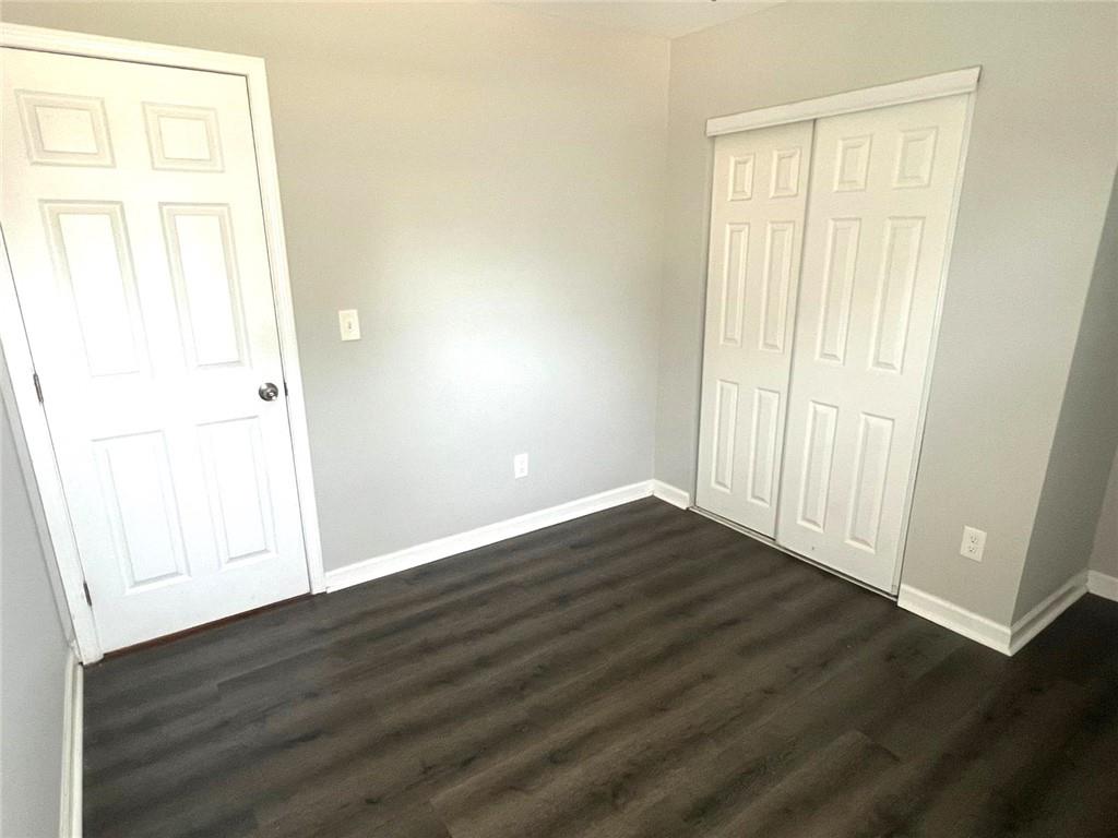 566 Rockwell Street Southwest Atlanta, GA 30310 - Photo 13 of 23 an empty room with wooden floor and windows