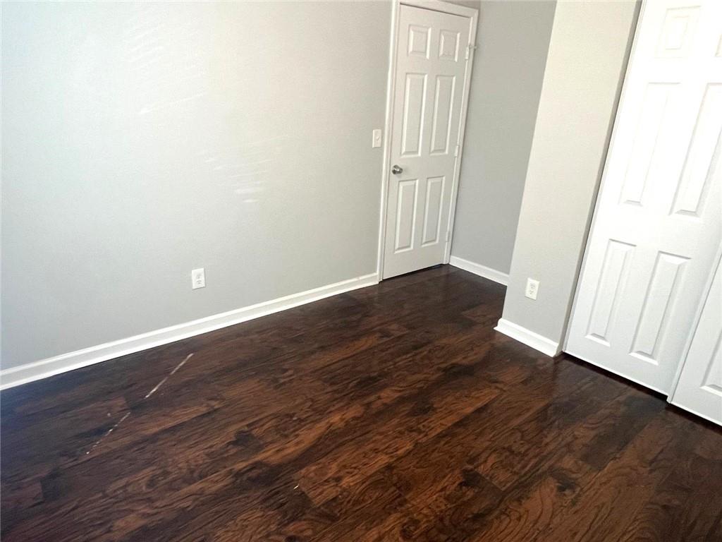 566 Rockwell Street Southwest Atlanta, GA 30310 - Photo 17 of 23 an empty room with wooden floor