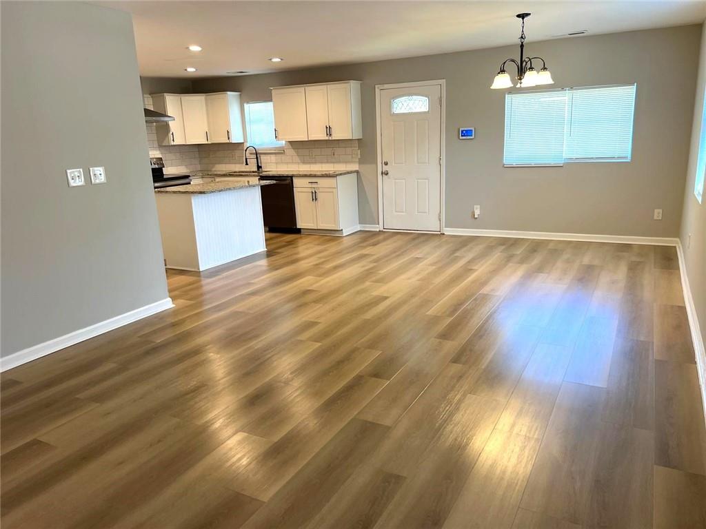 566 Rockwell Street Southwest Atlanta, GA 30310 - Photo 7 of 23 a open kitchen with cabinets wooden floor and stainless steel appliances