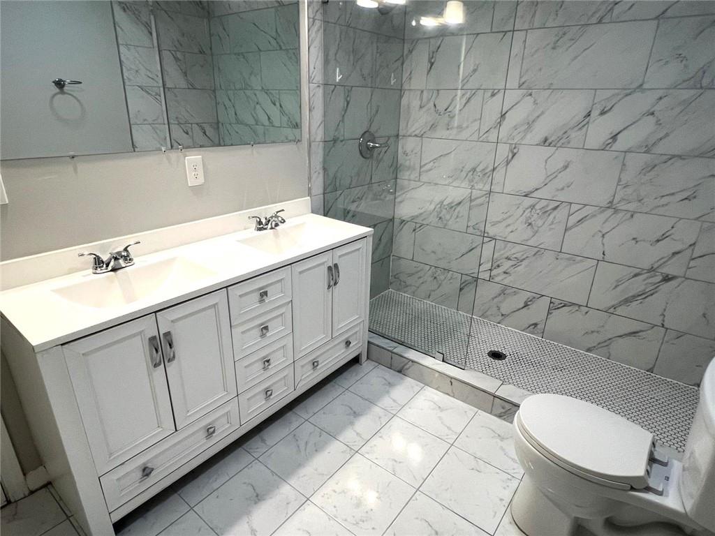 566 Rockwell Street Southwest Atlanta, GA 30310 - Photo 9 of 23 a bathroom with a double vanity sink toilet and shower