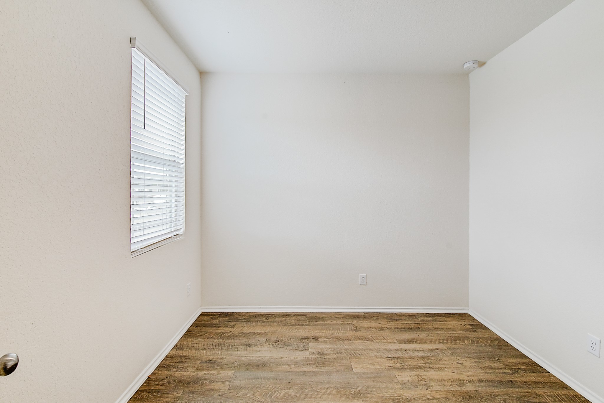 14468 Conifer Drive Conroe, TX 77302 - Photo 15 of 21 a view of an empty room with wooden floor and a window