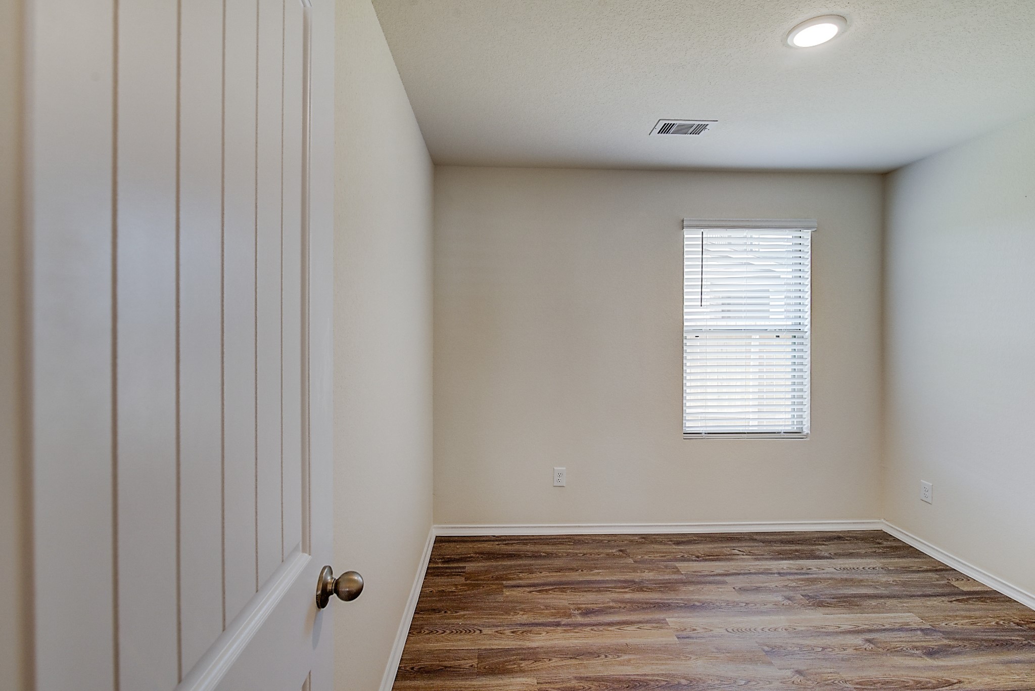14468 Conifer Drive Conroe, TX 77302 - Photo 19 of 21 a view of an empty room with wooden floor and a window