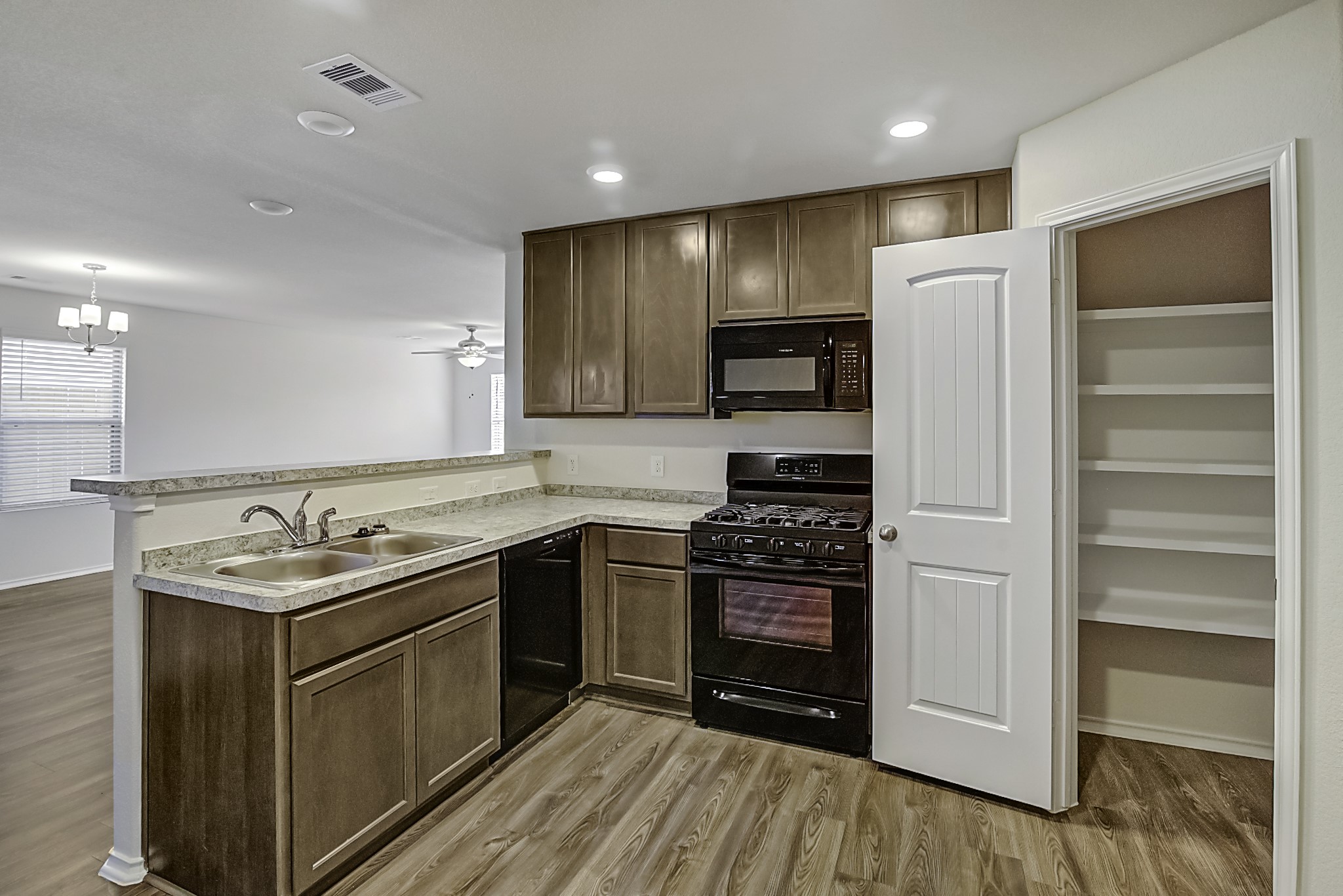 14468 Conifer Drive Conroe, TX 77302 - Photo 6 of 21 a kitchen with stainless steel appliances granite countertop a stove a refrigerator and a sink
