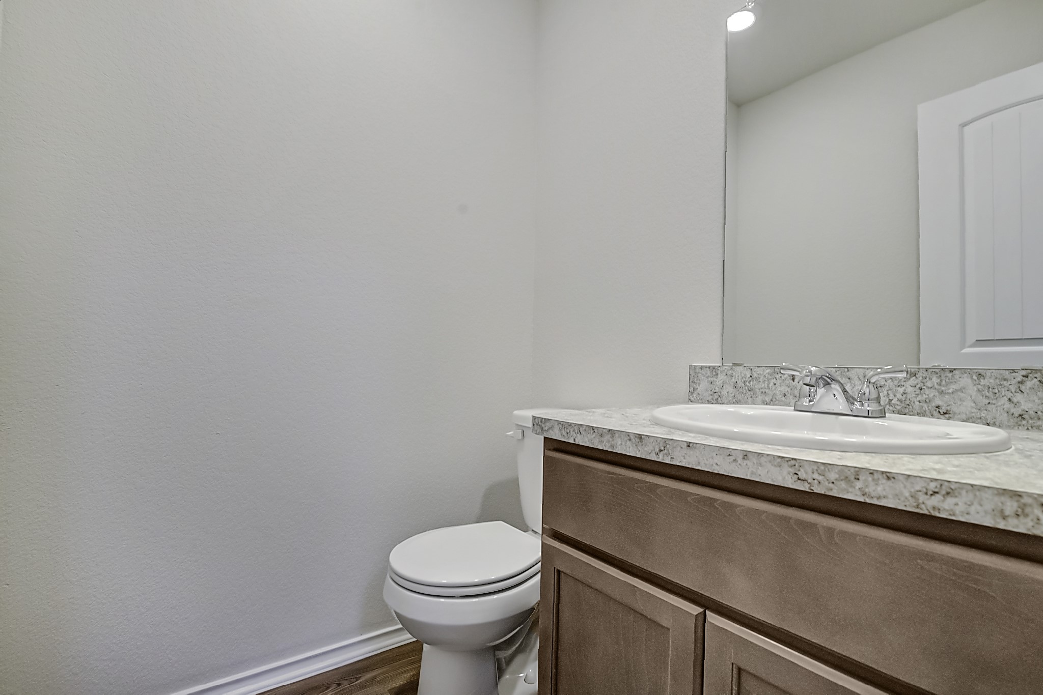 14468 Conifer Drive Conroe, TX 77302 - Photo 7 of 21 a bathroom with a granite countertop sink a toilet and mirror