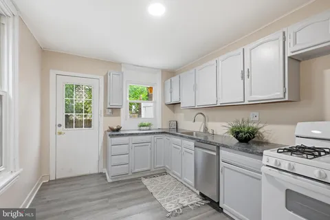a kitchen with a sink stove and cabinets