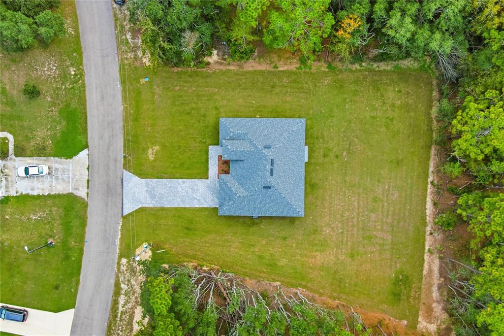 6312 Southwest 144th Lane Road Ocala, FL 34473 - Photo 4 of 32 an aerial view of a house with a yard