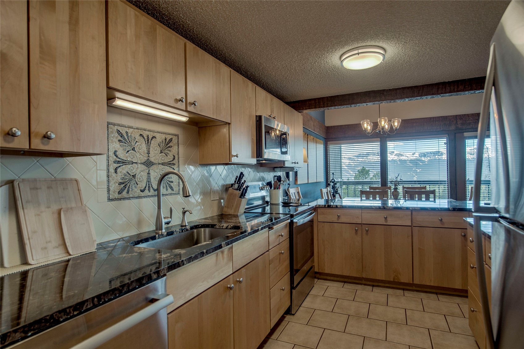 187 Fuller Placer Road, Unit B Breckenridge, CO 80424 - Photo 11 of 33 a kitchen with stainless steel appliances granite countertop a sink and a stove