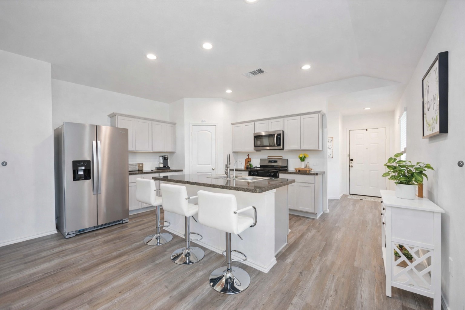 24034 Sunview Vly Drive Spring, TX 77373 - Photo 15 of 43 Kitchen – Island & Storage View
Well-designed kitchen featuring a large center island with seating, stainless steel appliances, and abundant cabinet and counter space. The open layout offers excellent functionality for meal prep, casual dining, and entertaining, while maintaining a clean, modern feel that connects easily to the rest of the home.